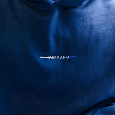 A detailed shot of a blue hoodie featuring a unique embroidered design.