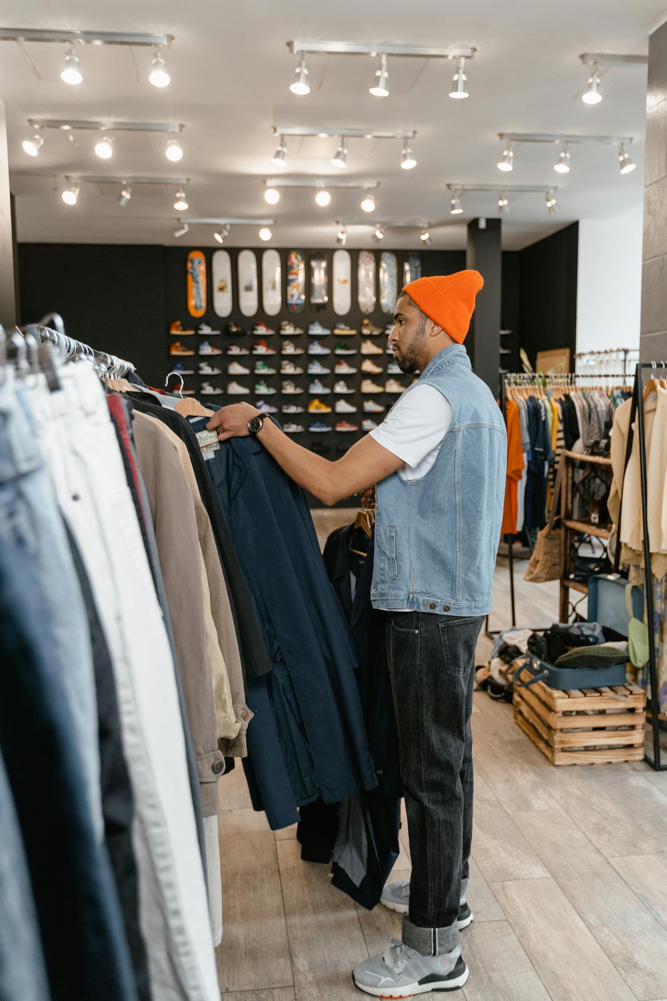 Stylish man exploring options in a modern urban fashion store.